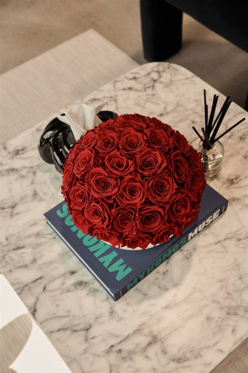 Red rose arrangement on marble coffee table